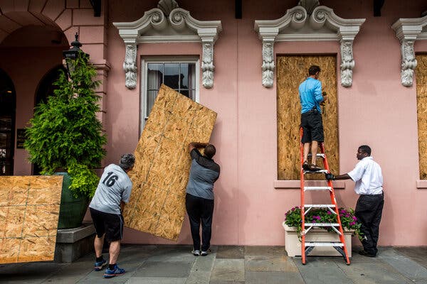 Workers installing protective panels at the Mills House Wyndham Grand Hotel in Charleston ahead of Hurricane Florence in 2018.